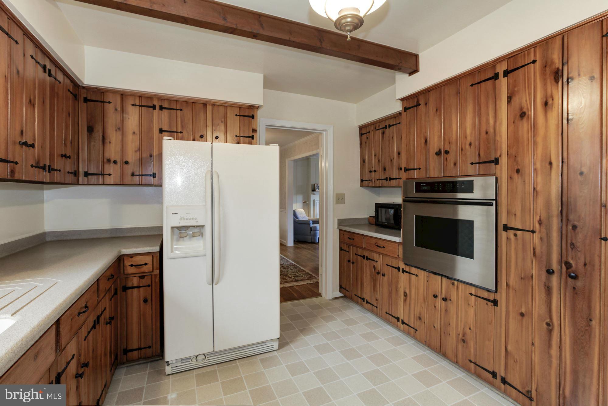 5502 Pollard Road Bethesda, MD 20816 - Photo 11 of 30 a kitchen with granite countertop a refrigerator and a stove top oven