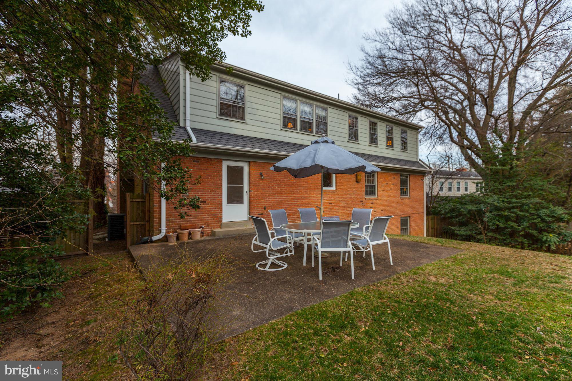 5502 Pollard Road Bethesda, MD 20816 - Photo 28 of 30 a backyard of a house with a table and chairs