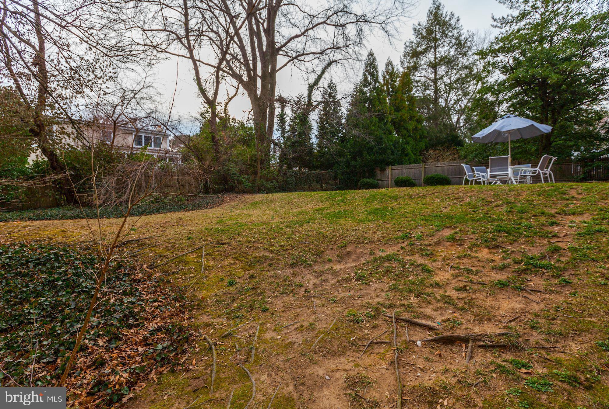 5502 Pollard Road Bethesda, MD 20816 - Photo 29 of 30 a backyard of a house with yard and outdoor seating