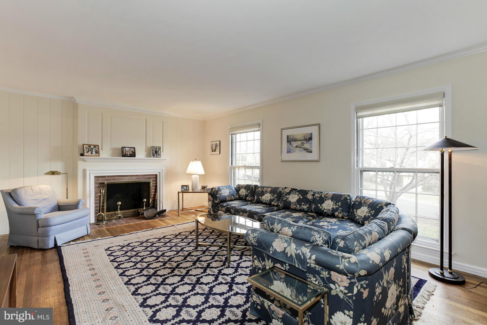 5502 Pollard Road Bethesda, MD 20816 - Photo 5 of 30 a living room with furniture large window and a fireplace