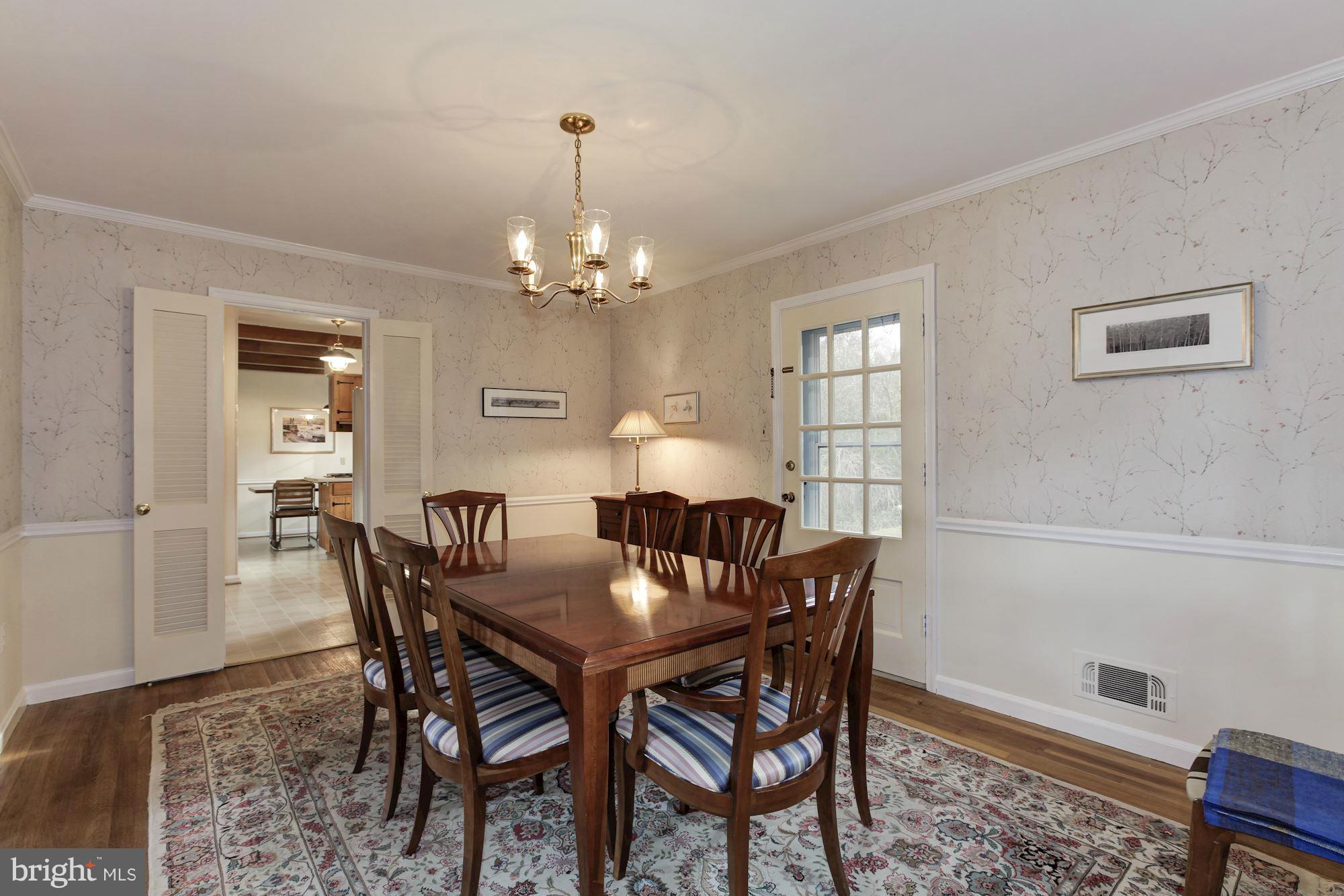 5502 Pollard Road Bethesda, MD 20816 - Photo 8 of 30 a view of a dining room with furniture and chandelier