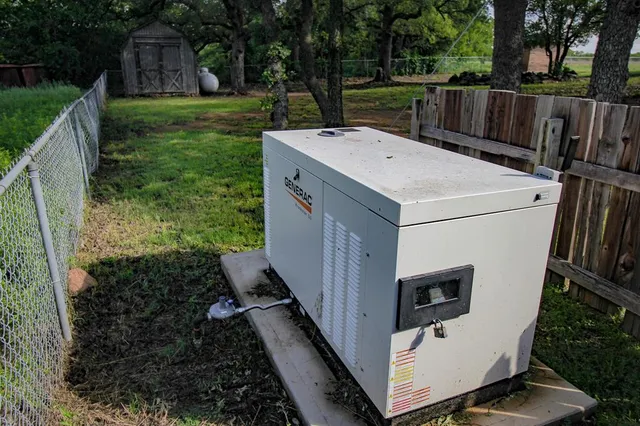 a view of a backyard with wooden fence and large trees