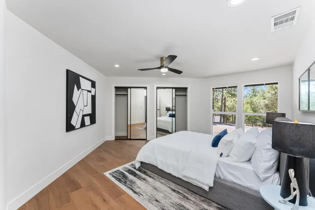 a bedroom with a bed and a mirror