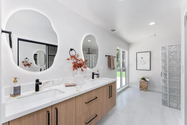 a view of a patio with table and chairs under an umbrella with wooden floor