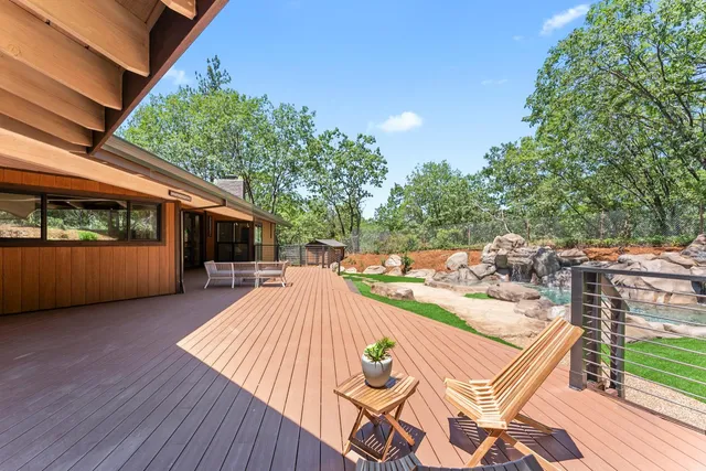a front view of house with yard and trees in the background