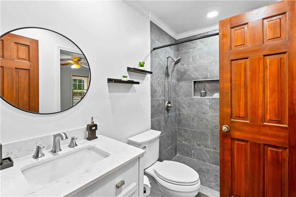 894 Upper Woolsey Road Hampton, GA 30228 - Photo 16 of 96 a bathroom with a sink toilet and shower