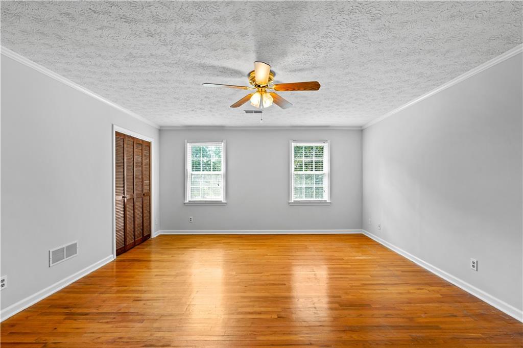 894 Upper Woolsey Road Hampton, GA 30228 - Photo 38 of 96 a view of empty room with window and wooden floor