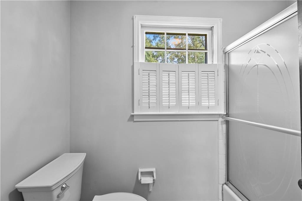894 Upper Woolsey Road Hampton, GA 30228 - Photo 42 of 96 a bathroom with a toilet a sink and a window