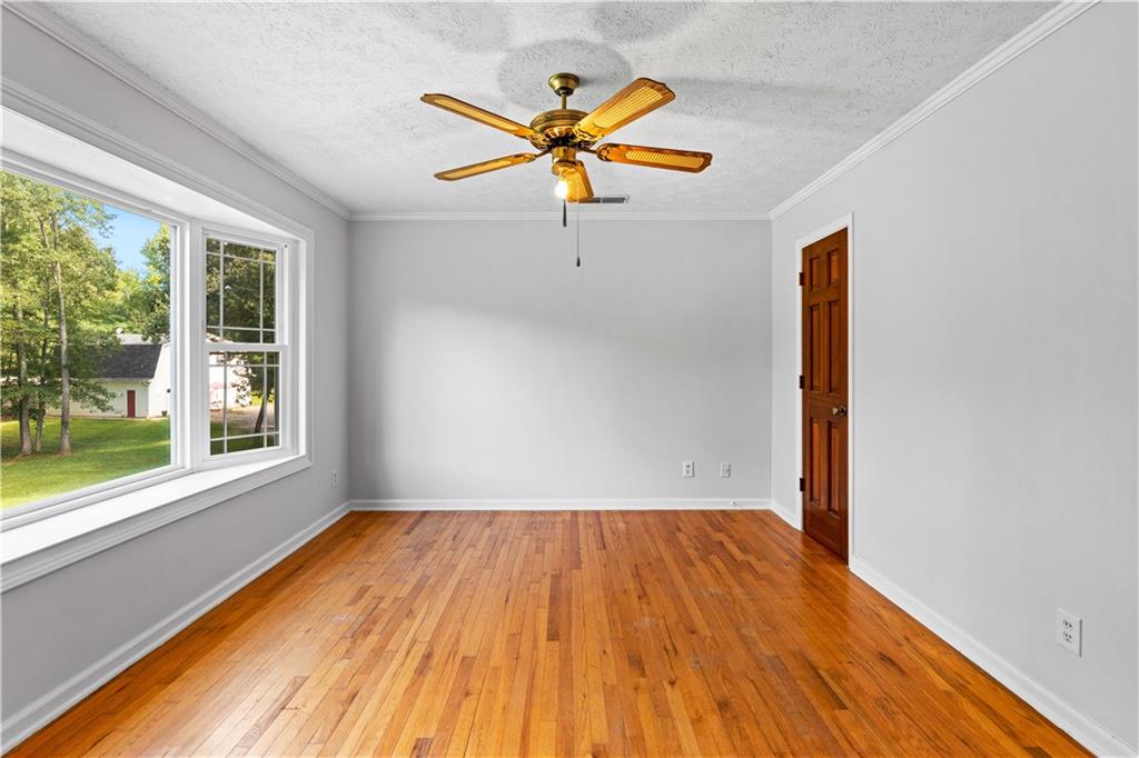 894 Upper Woolsey Road Hampton, GA 30228 - Photo 50 of 96 a view of a room with wooden floor and a ceiling fan