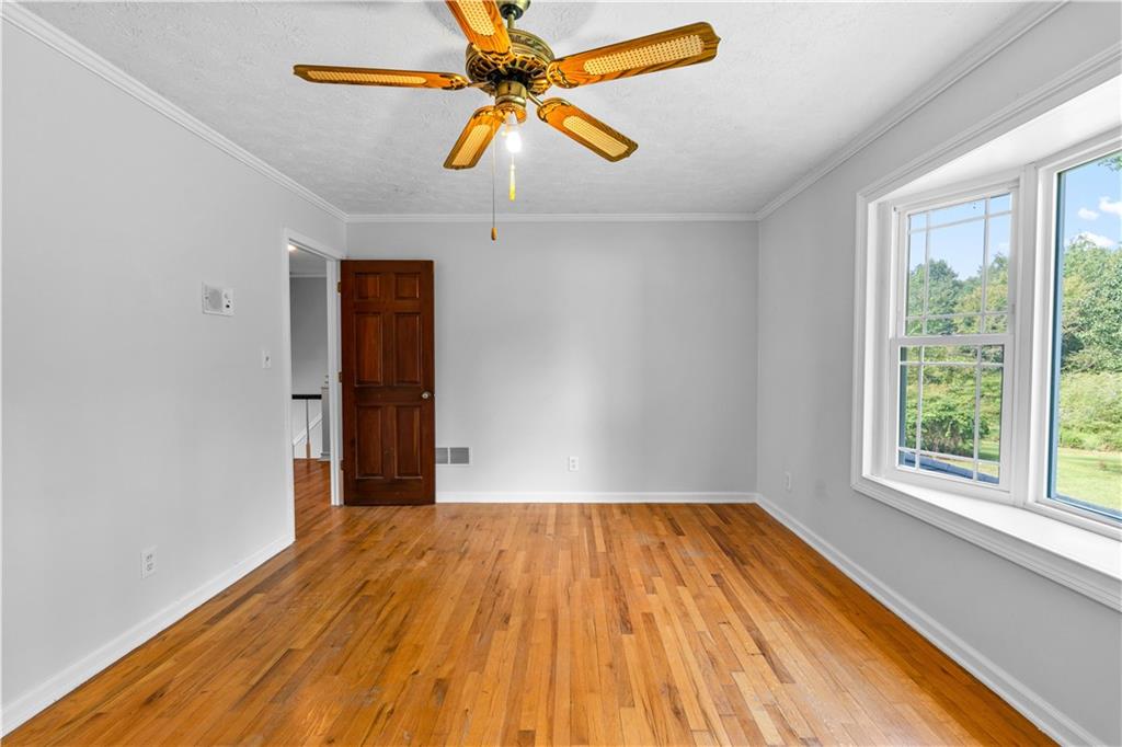 894 Upper Woolsey Road Hampton, GA 30228 - Photo 52 of 96 a view of empty room with wooden floor and fan