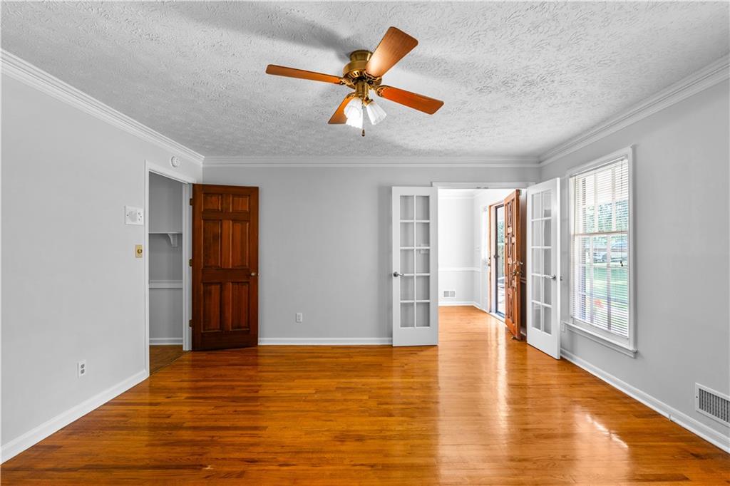 894 Upper Woolsey Road Hampton, GA 30228 - Photo 9 of 96 a view of an empty room with window and wooden floor