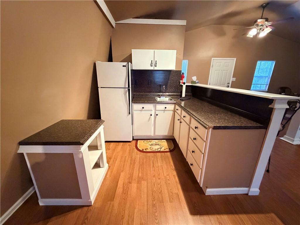 894 Upper Woolsey Road Hampton, GA 30228 - Photo 95 of 96 a kitchen with stainless steel appliances a stove top oven a sink and a refrigerator