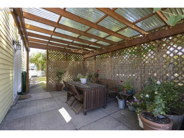a view of a patio with table and chairs and potted plants