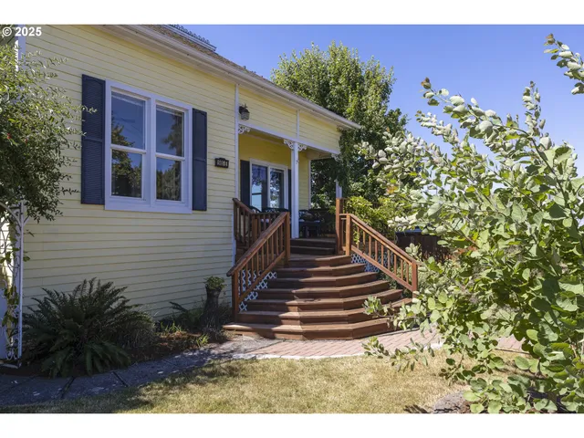 a view of a house with more windows and flower plants
