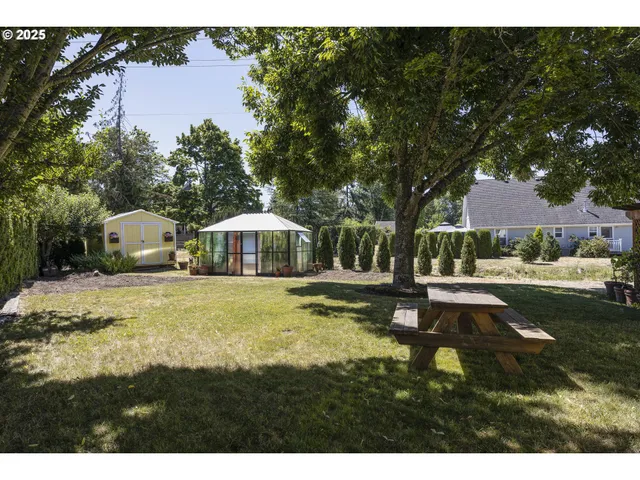 a view of a house with swimming pool and sitting area