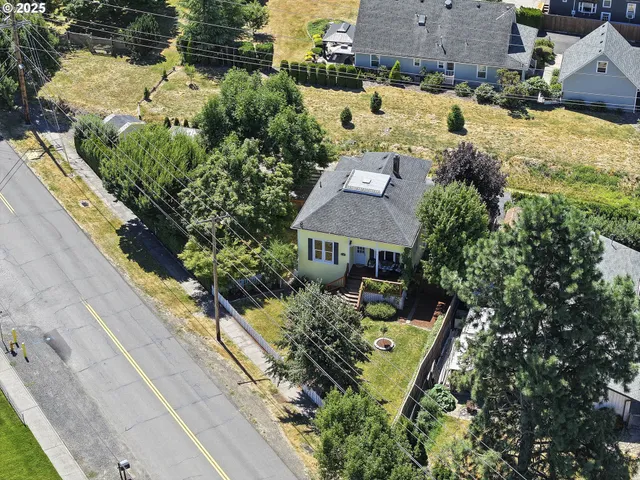 an aerial view of a house with a yard