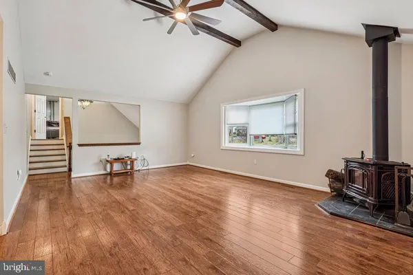 a kitchen with granite countertop a stove a sink dishwasher and a refrigerator with wooden floor