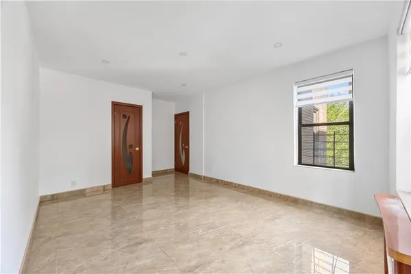 an empty room with windows and closet