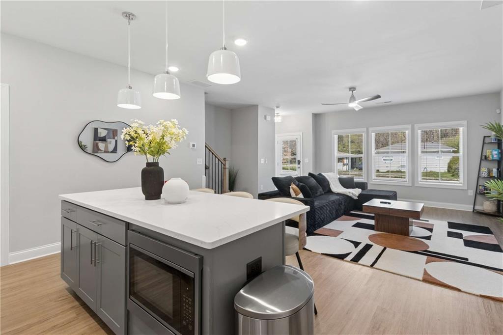 1324 Parc Bench Road Atlanta, GA 30316 - Photo 12 of 35 a living room with kitchen island furniture and a chandelier