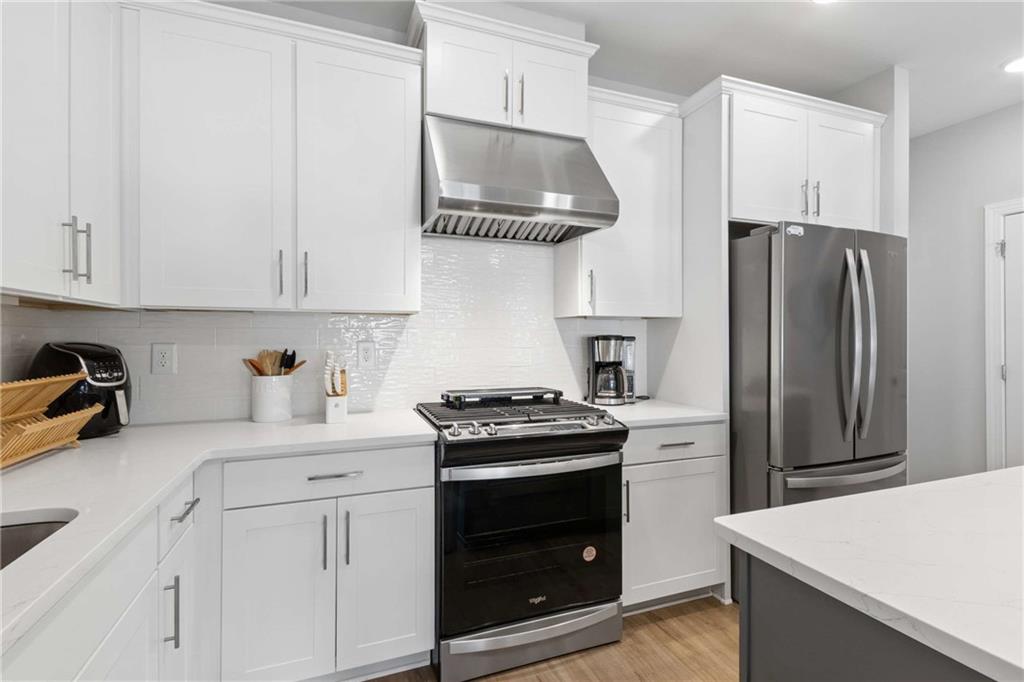 1324 Parc Bench Road Atlanta, GA 30316 - Photo 16 of 35 a kitchen with stainless steel appliances granite countertop a refrigerator stove and white cabinets