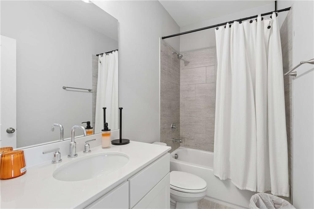 1324 Parc Bench Road Atlanta, GA 30316 - Photo 24 of 35 a bathroom with a sink a toilet and shower curtain