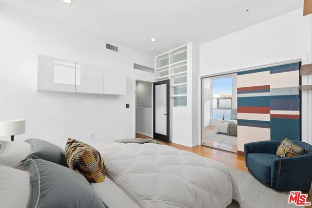 a bedroom with furniture and a window