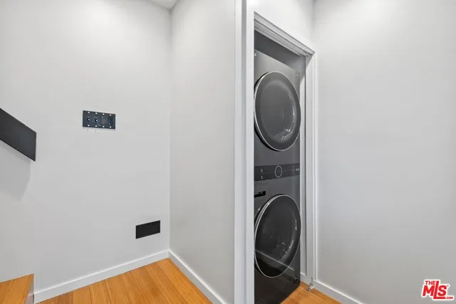 a view of a storage and utility room with washer and dryer
