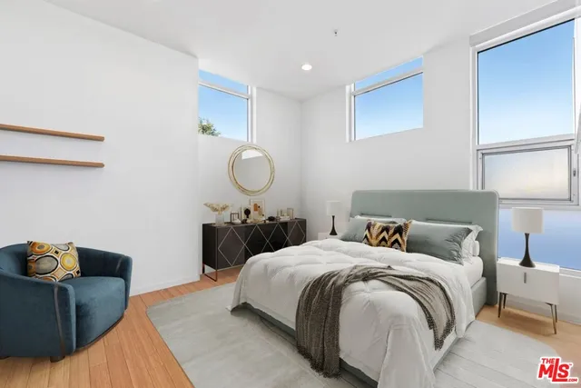 a bedroom with two beds and painting on the wall