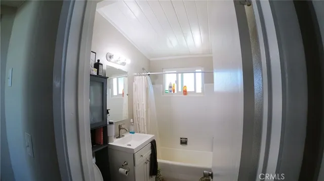 a bathroom with a sink mirror and shower