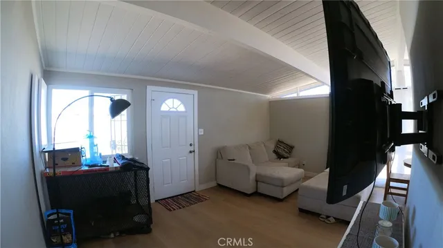 a living room with furniture and a mirror