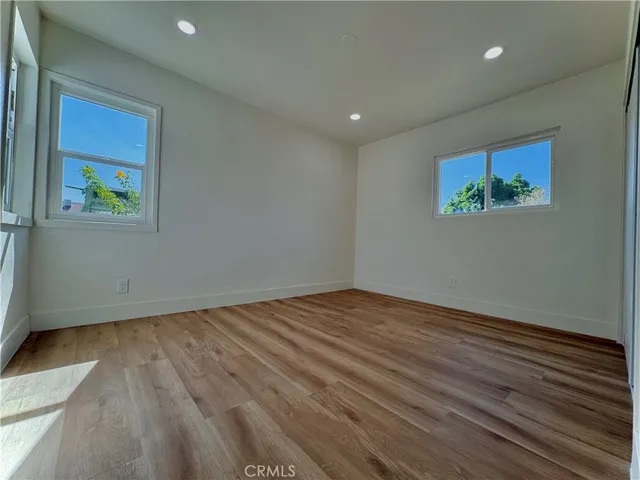 a view of room with wooden floor and window