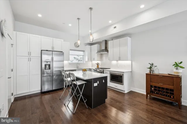 a kitchen with a sink window and cabinets