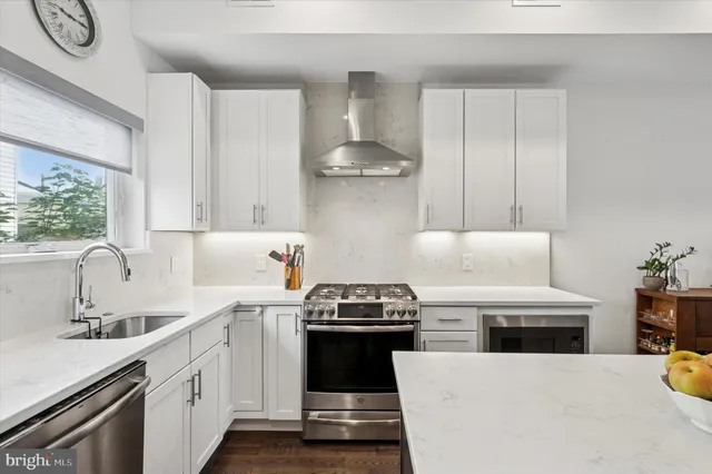a large kitchen with a table and chairs