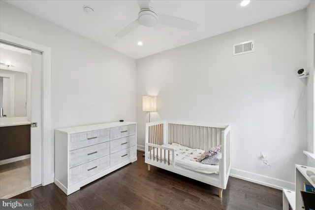 a living room with baby crib furniture and a window