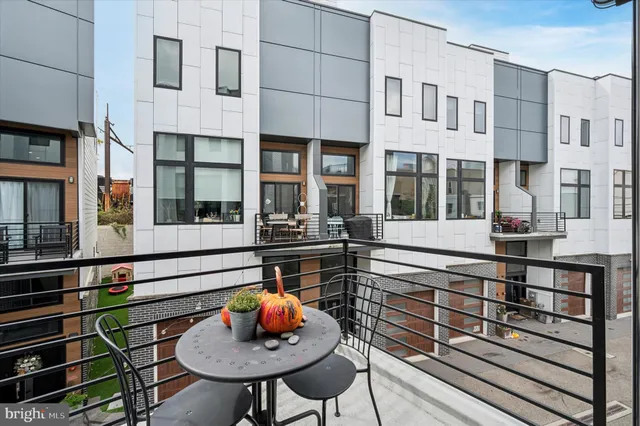 a view of staircase with wooden floor and white walls