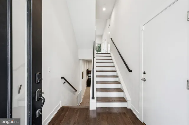 a view of a workspace with furniture and wooden floor