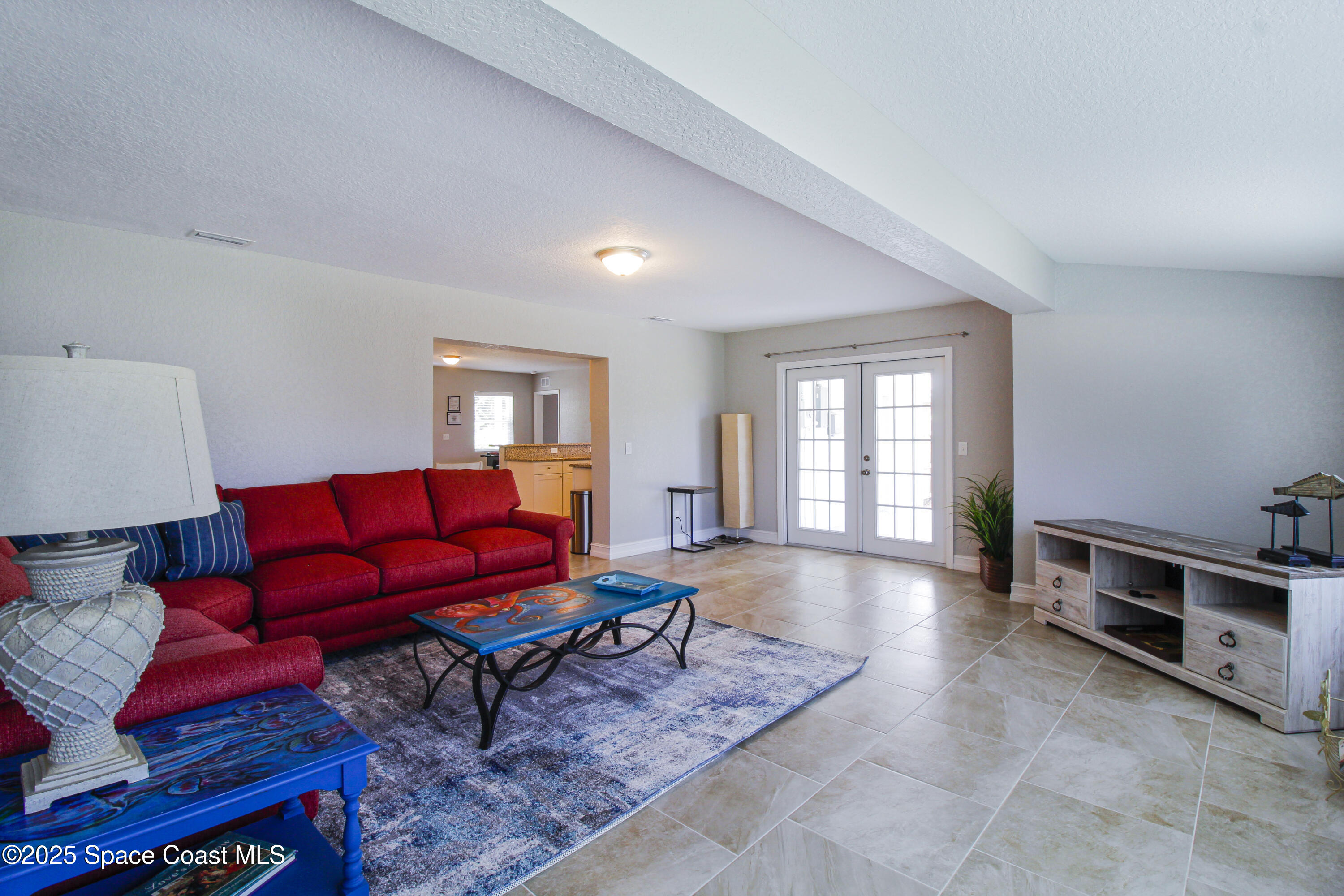 827 Glenmore Circle Melbourne, FL 32901 - Photo 11 of 30 a living room with furniture a rug and a window