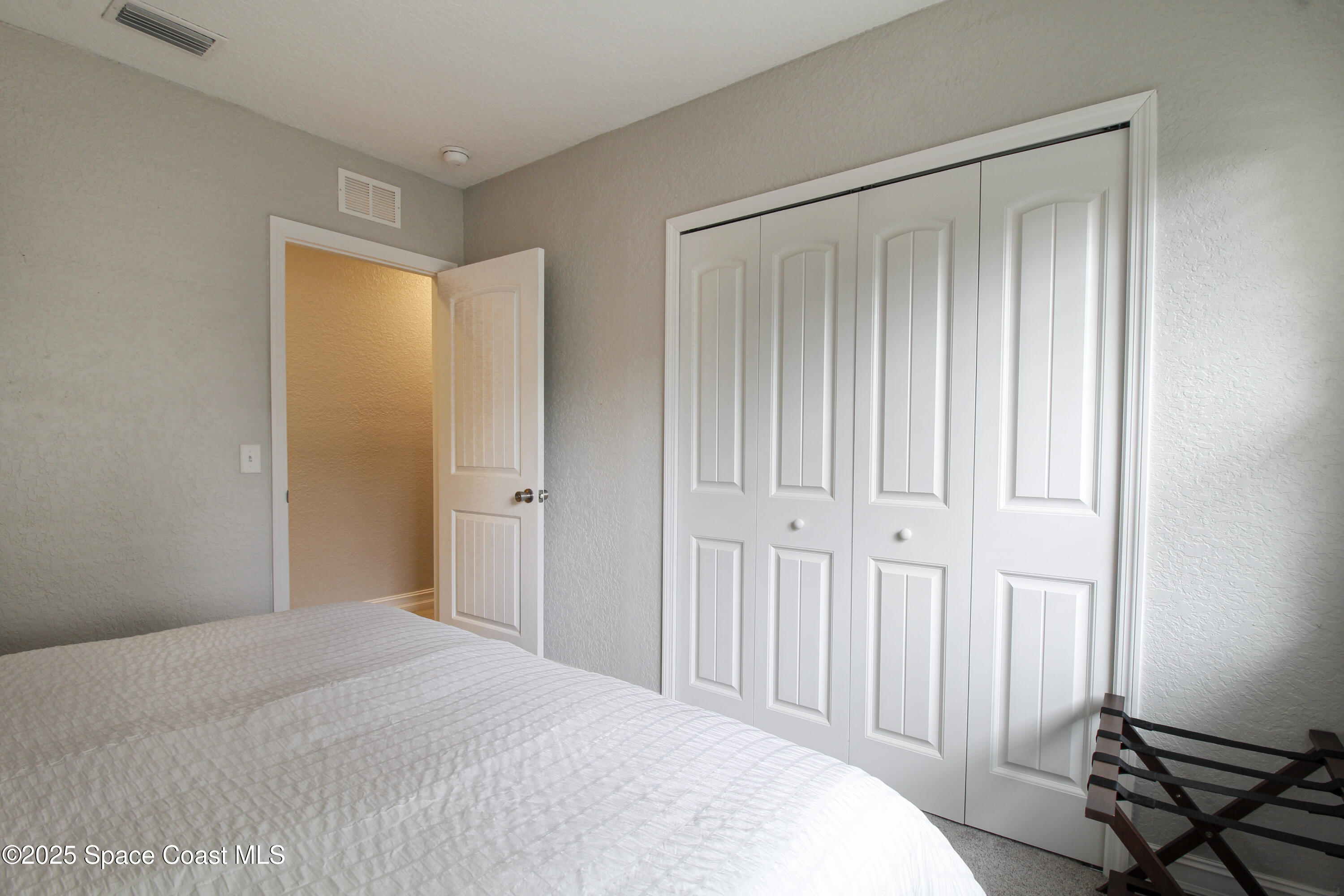 827 Glenmore Circle Melbourne, FL 32901 - Photo 18 of 30 a bedroom with a bed and a window