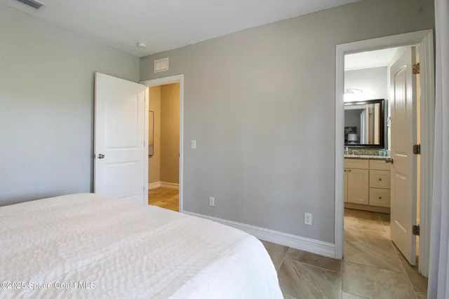 a bedroom with a bed and a view of bathroom