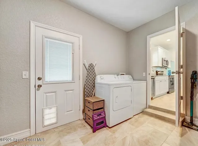 a utility room with dryer and washer