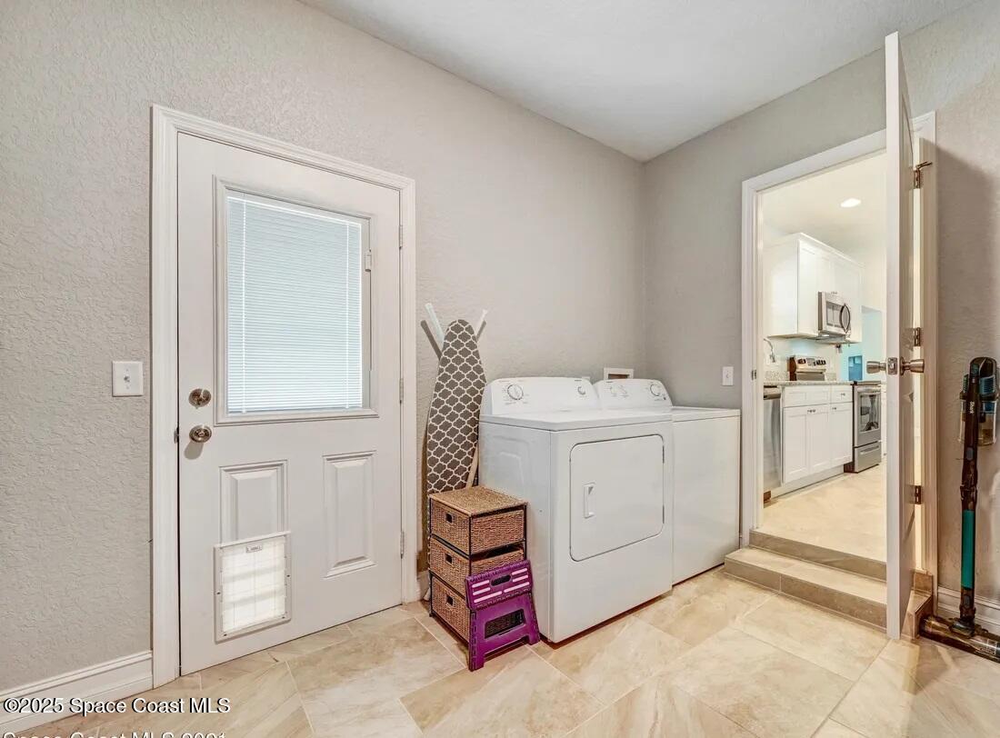 827 Glenmore Circle Melbourne, FL 32901 - Photo 24 of 30 a utility room with dryer and washer