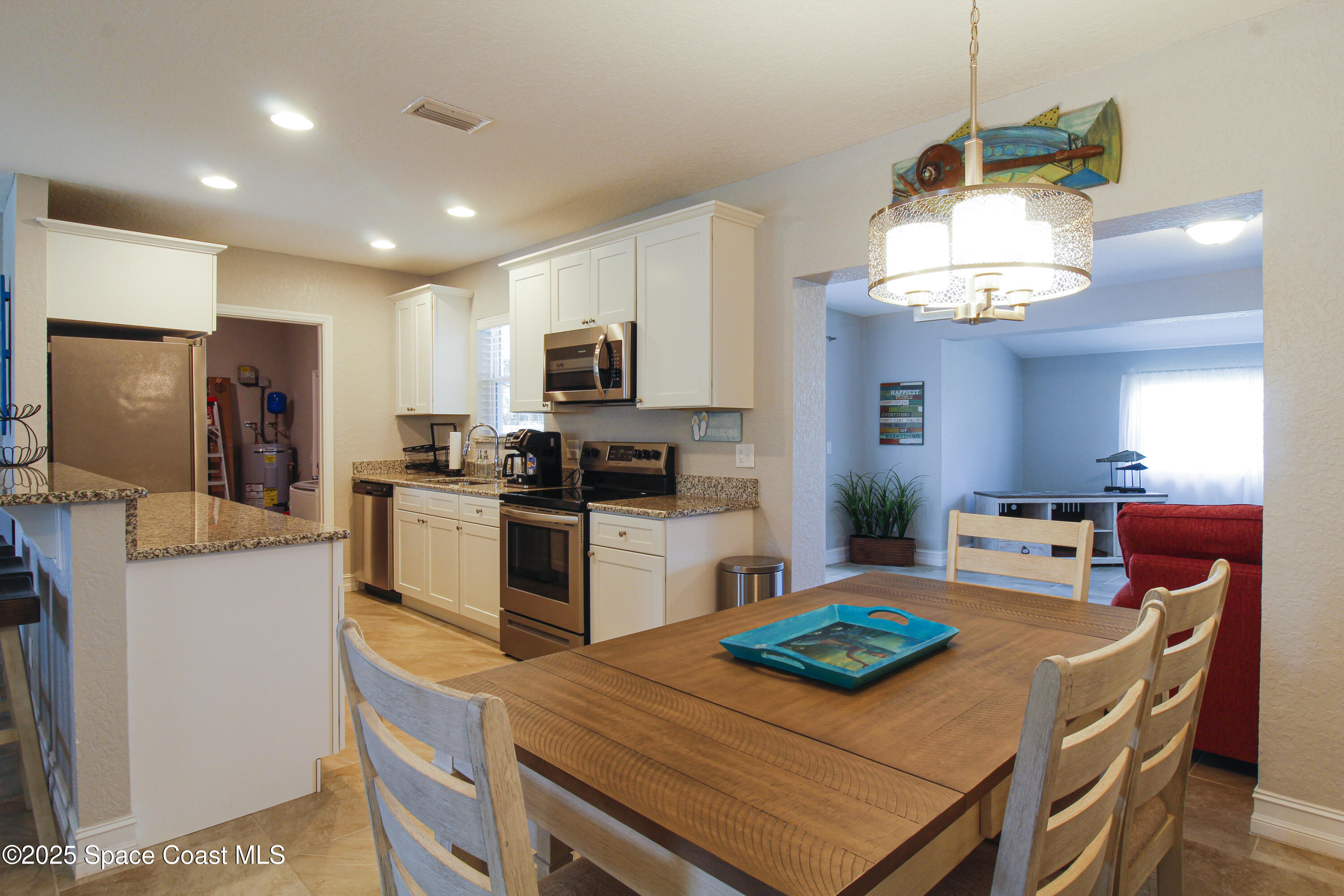 827 Glenmore Circle Melbourne, FL 32901 - Photo 6 of 30 a kitchen with kitchen island a white counter space cabinets and appliances