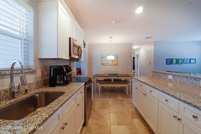 a kitchen with a stove sink and cabinets