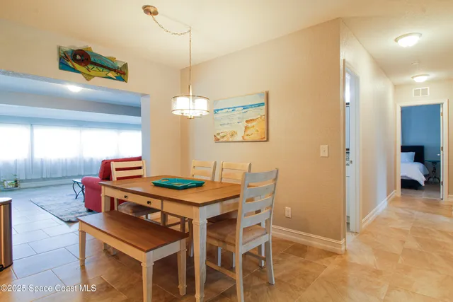 a dining room with a table and chairs