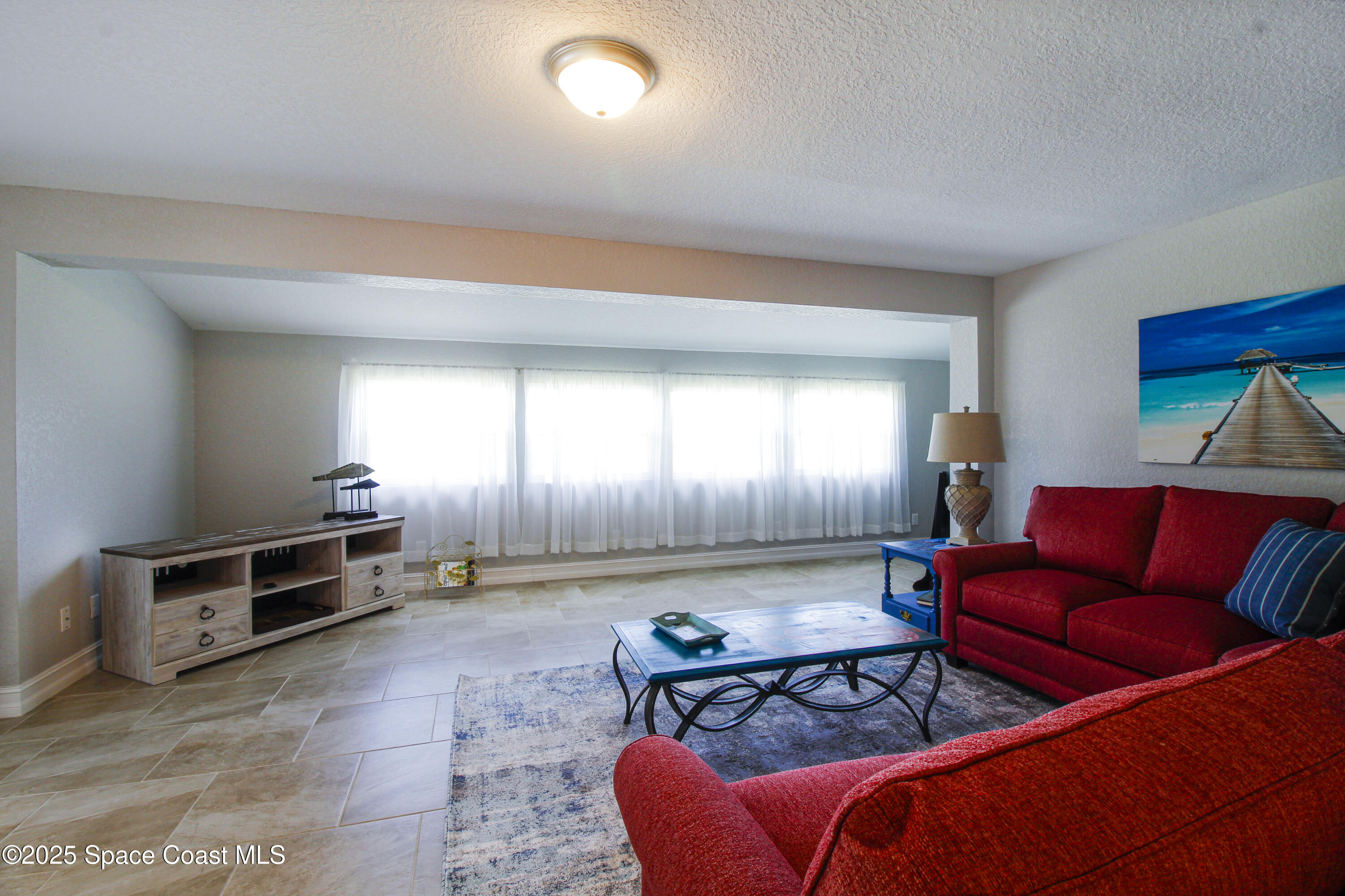 827 Glenmore Circle Melbourne, FL 32901 - Photo 9 of 30 a living room with furniture and a window