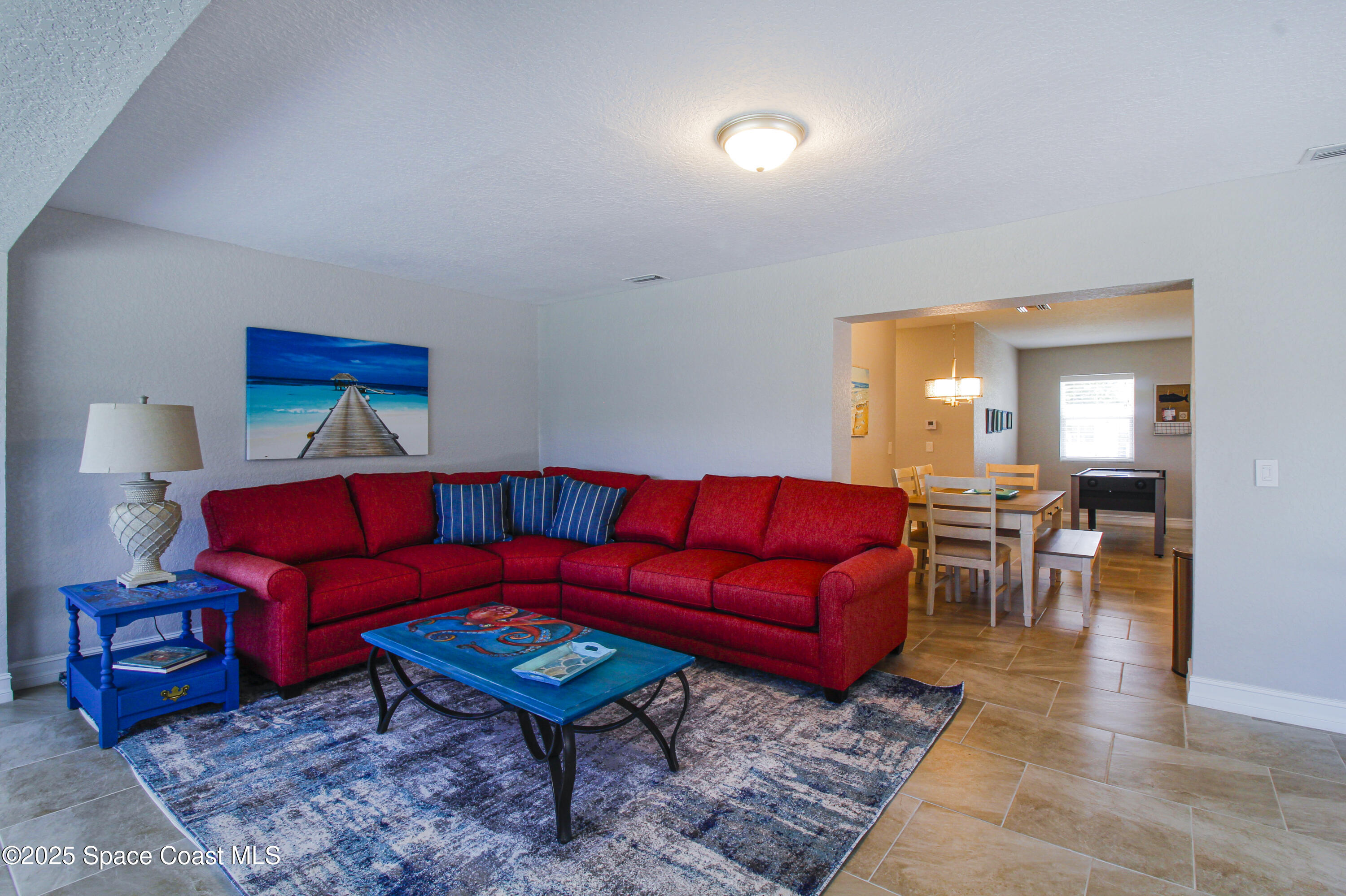 827 Glenmore Circle Melbourne, FL 32901 - Photo 10 of 30 a living room with furniture a piano and a table