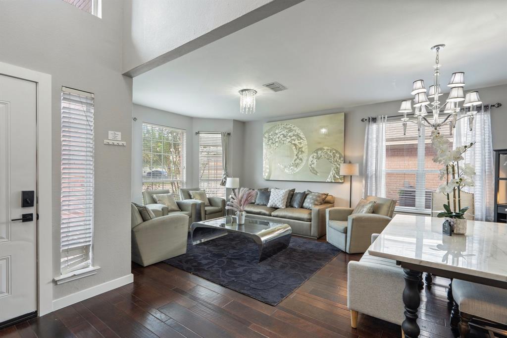 a living room with fireplace furniture and a chandelier