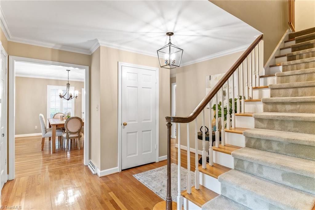 1318 Robinhood Road High Point, NC 27262 - Photo 11 of 43 Foyer entry displays Dining area to the left. Formal staircase leads to upstairs bedrooms. There is also a private staircase off the kitchen leading to the Bonus area + bedrooms.