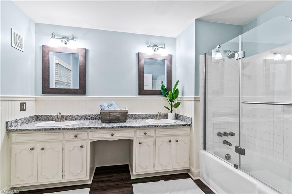 1318 Robinhood Road High Point, NC 27262 - Photo 24 of 43 Updated Master Bath ~ Granite Counters, new flooring, all new lighting and Mirrors, New glass shower door