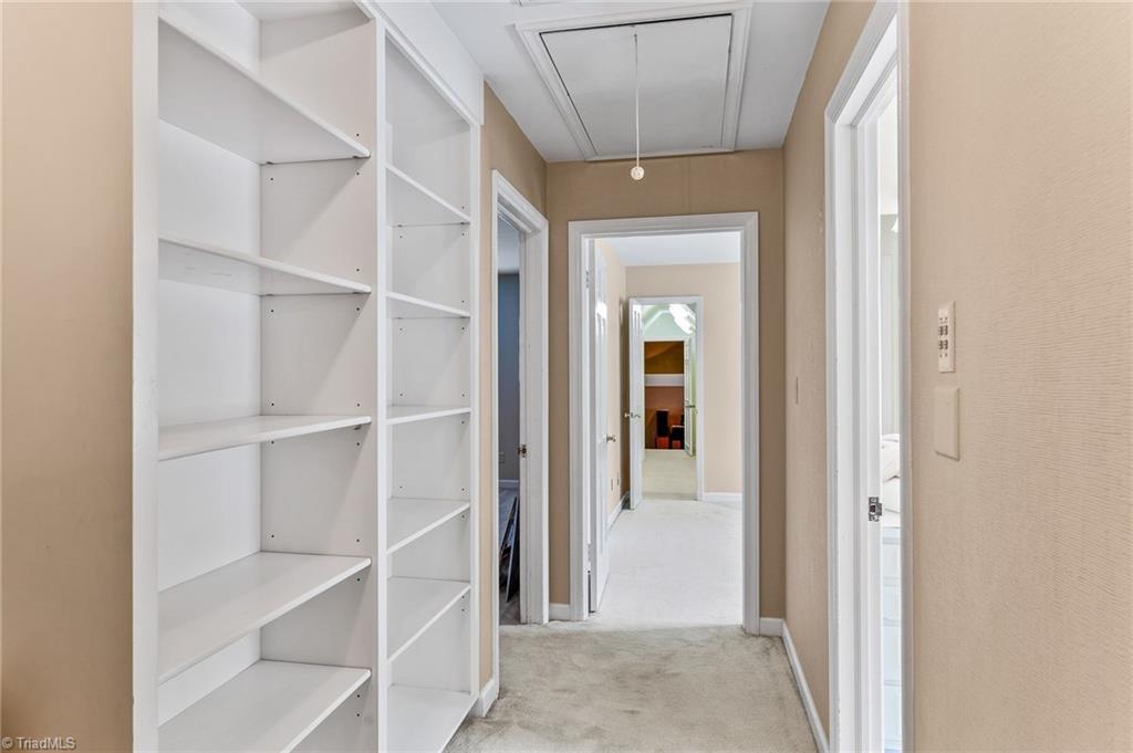 1318 Robinhood Road High Point, NC 27262 - Photo 32 of 43 Upstairs hallway between bedrooms boasts built in shelving